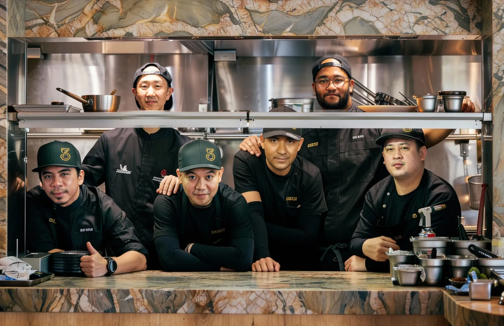 The 3Fils kitchen crew posing together at the pass